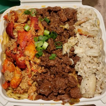 Chef Smelly's - Surf n turf on top of garlic noodles. - Cajun/Creole Near Me - Oakland, California