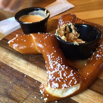 Carillon Brewing - Half eaten pretzel served with beer cheese and mustard. - Breweries Near Me - Dayton, Ohio Carillon Brewing - Half eaten pretzel served with beer cheese and mustard. - Breweries Near Me - Dayton, Ohio