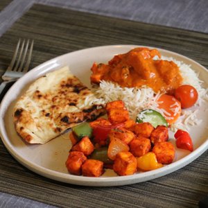 Photo of Yelp Elite Experience: Masala Desi Cafe RWC - Redwood City, CA, United States. Butter chicken lunch special and chili paneer (Included greens not pictured bc we accidentally microwaved em)