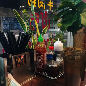 Pho 777 - a table with a variety of condiments - Vietnamese Near Me - Chicago, Illinois