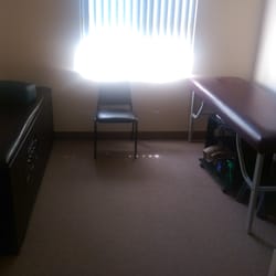 Jill's Family Chiropractic Center - Waiting area with massage tables and tens units