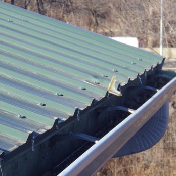 Seamless Exterior - Snow guard falling into gutter. Four year warranty, bogus. Rain water overflows. Downspouts clogged by bogus snow guards. - Gutter Services Near Me - Cedar Falls, Iowa