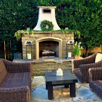 My Botanica - a patio with wicker furniture and a fireplace - Landscaping Near Me - Laguna Beach, California My Botanica - a patio with wicker furniture and a fireplace - Landscaping Near Me - Laguna Beach, California