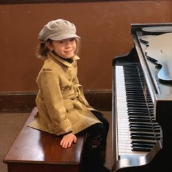A student looking proud after performing in our Mystery themed recital!