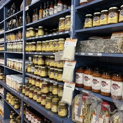 Just a portion of the long wall of related groceries of ingredients, sauces and dried goods