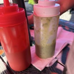 Bottles of green and red salsa can be found in their outdoor fridge Bottles of green and red salsa can be found in their outdoor fridge