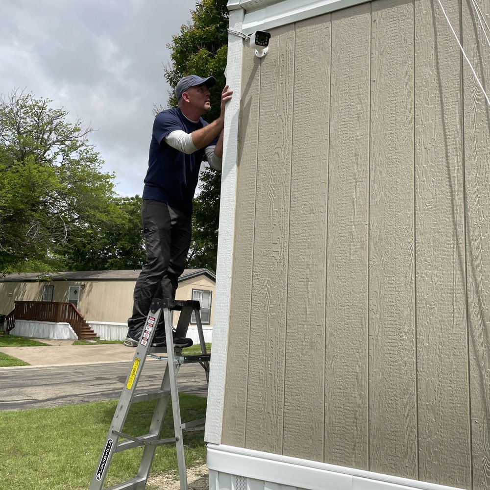 DVI - Here he is setting up both the front camera and the front left side camera.  He has it set up so that there will be nearly complete coverage - Security Systems Near Me