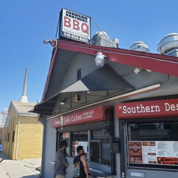 Johnson Brothers BBQ - two people standing outside of a restaurant - Barbeque Near Me - Compton, California