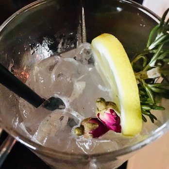 Bustan - Persian Lemonade cocktail with gin instead of vodka. It has rose petal jam and rose buds - Mediterranean Near Me - New York, New York