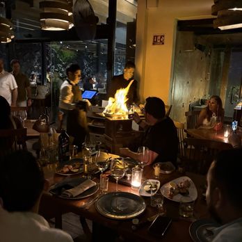RosaNegra Cancun - Tomahawk steak being prepped for a separate table - Steakhouses Near Me - Cancún, ROO RosaNegra Cancun - Tomahawk steak being prepped for a separate table - Steakhouses Near Me - Cancún, ROO