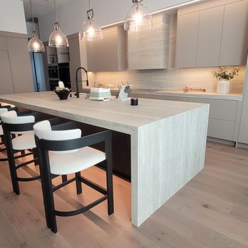 Kitchen Designs and More - Modern Kitchen; Large Island; Waterfalls on Both Sides; Neolith Sintered Stone Countertops and Backsplash including Exhaust Hood - Kitchen & Bath Near Me - Weston, Florida Kitchen Designs and More - Modern Kitchen; Large Island; Waterfalls on Both Sides; Neolith Sintered Stone Countertops and Backsplash including Exhaust Hood - Kitchen & Bath Near Me - Weston, Florida