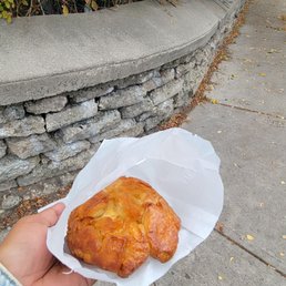 a person holding a pastry a person holding a pastry