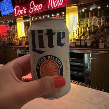Palomino Bar - a person holding a can of beer - Southern Near Me - Milwaukee, Wisconsin