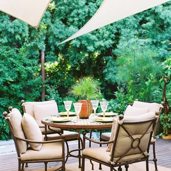 Paradise Gardens - a patio with a table and chairs - Landscaping Near Me Paradise Gardens - a patio with a table and chairs - Landscaping Near Me