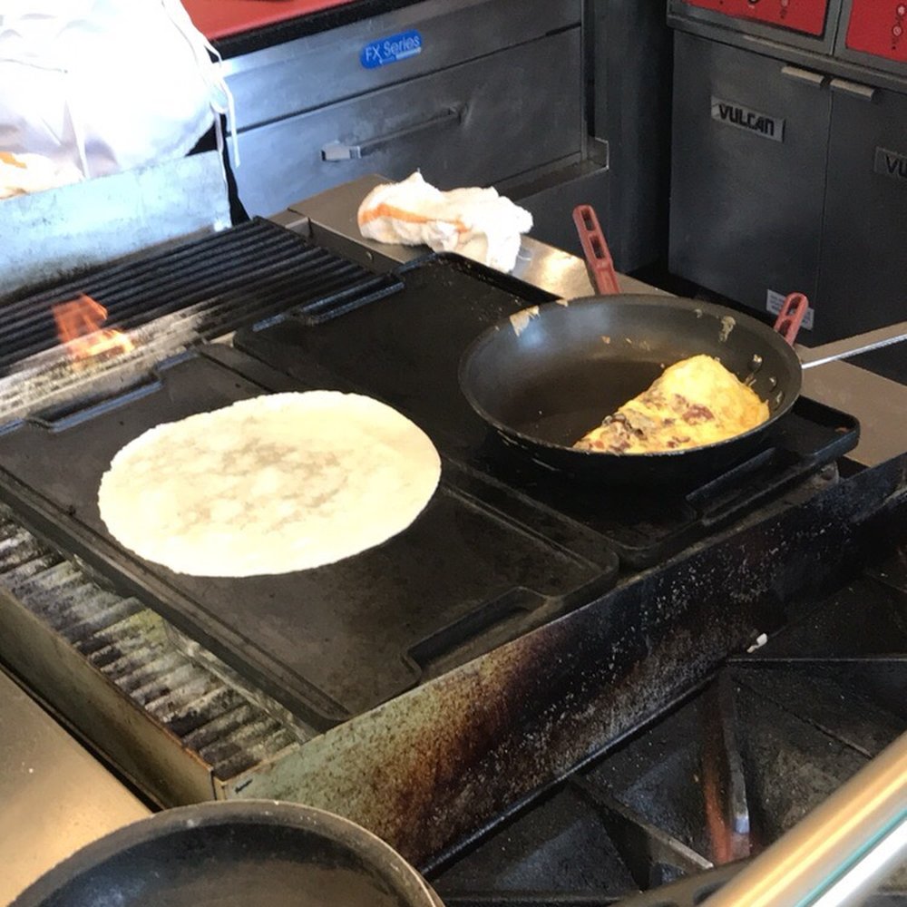 Cityfront Cafe - a pan of food cooking on a gas stove - Cafes Near Me - Chicago, Illinois