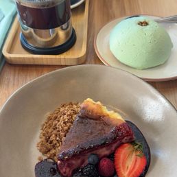 Cheesecake, pistachio concha, and French press Cheesecake, pistachio concha, and French press