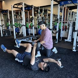 HypeCore Fitness - Team Athlete Julian showing one of our clients steps on repairing lower back!