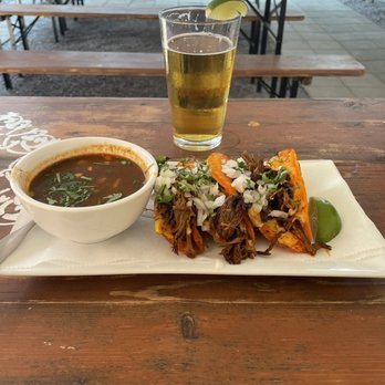 Casa Oaxaca - Birria tacos with consommé, Pacifico beer, on the covered patio. - Mexican Near Me - Bethesda, Maryland