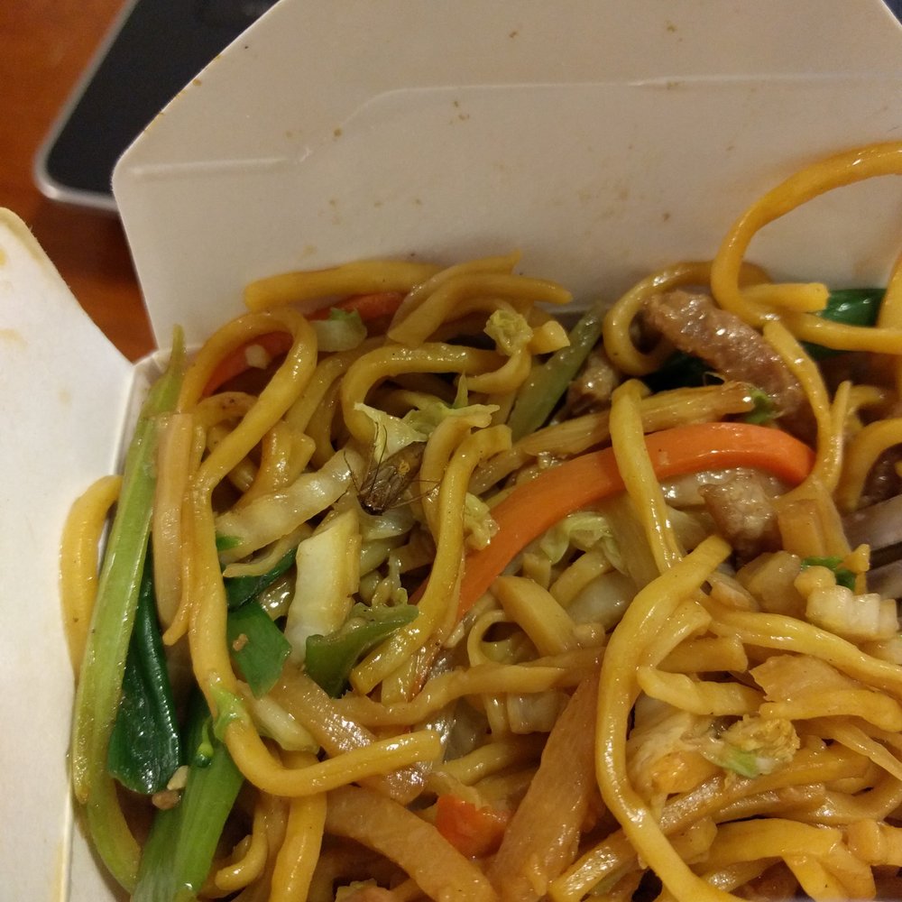 noodles and vegetables in a take out container noodles and vegetables in a take out container