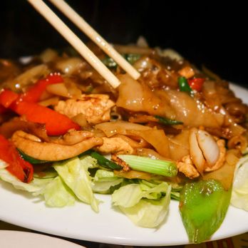 Toi On Sunset - a plate of food with chopsticks - Thai Near Me - Los Angeles, California Toi On Sunset - a plate of food with chopsticks - Thai Near Me - Los Angeles, California
