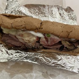 a sandwich wrapped in tin foil a sandwich wrapped in tin foil