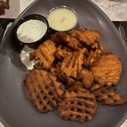 Sweet Potato Waffle Fries with sides of ranch and cheese sauce Sweet Potato Waffle Fries with sides of ranch and cheese sauce