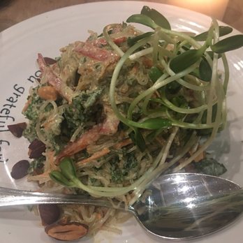 Cafe Gratitude - So flavorful - I am "liberated": thai almond sauce, carrots, red bell pepper, kale, toasted almonds, sprouts - Vegan Near Me - Venice, California Cafe Gratitude - So flavorful - I am "liberated": thai almond sauce, carrots, red bell pepper, kale, toasted almonds, sprouts - Vegan Near Me - Venice, California