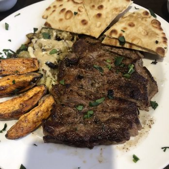 Elsas Greek Grill - 12oz ribeye, roasted potatoes, baba ganoush, and pita bread. - Greek Near Me - Beaumont, Texas Elsas Greek Grill - 12oz ribeye, roasted potatoes, baba ganoush, and pita bread. - Greek Near Me - Beaumont, Texas