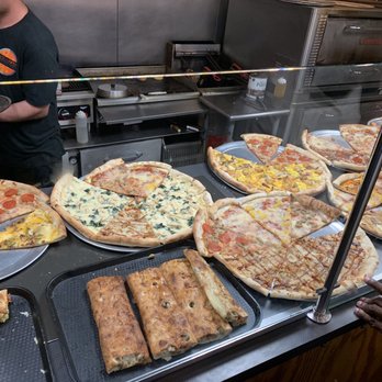 Sal's on Fifth - a man standing in front of a counter of pizzas - Pizza Near Me - Minneapolis, Minnesota Sal's on Fifth - a man standing in front of a counter of pizzas - Pizza Near Me - Minneapolis, Minnesota