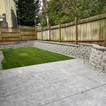 Sione's Concrete Construction Group - Stamped concrete, retaining wall, and new grass in the backyard. - Masonry/Concrete Near Me Sione's Concrete Construction Group - Stamped concrete, retaining wall, and new grass in the backyard. - Masonry/Concrete Near Me