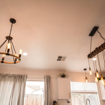 Danny's Floors - a kitchen with white cabinets and a chandelier - Flooring Near Me - Elk Grove, California Danny's Floors - a kitchen with white cabinets and a chandelier - Flooring Near Me - Elk Grove, California
