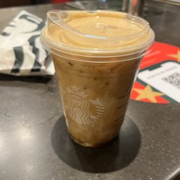 a cup of iced coffee on a counter