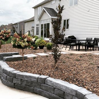 CLM Landscaping - a patio with a table and chairs - Landscaping Near Me - East Lansing, Michigan CLM Landscaping - a patio with a table and chairs - Landscaping Near Me - East Lansing, Michigan