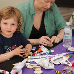 Essex Art Center - A young attendee makes art during Essex Art Center's annual block party.