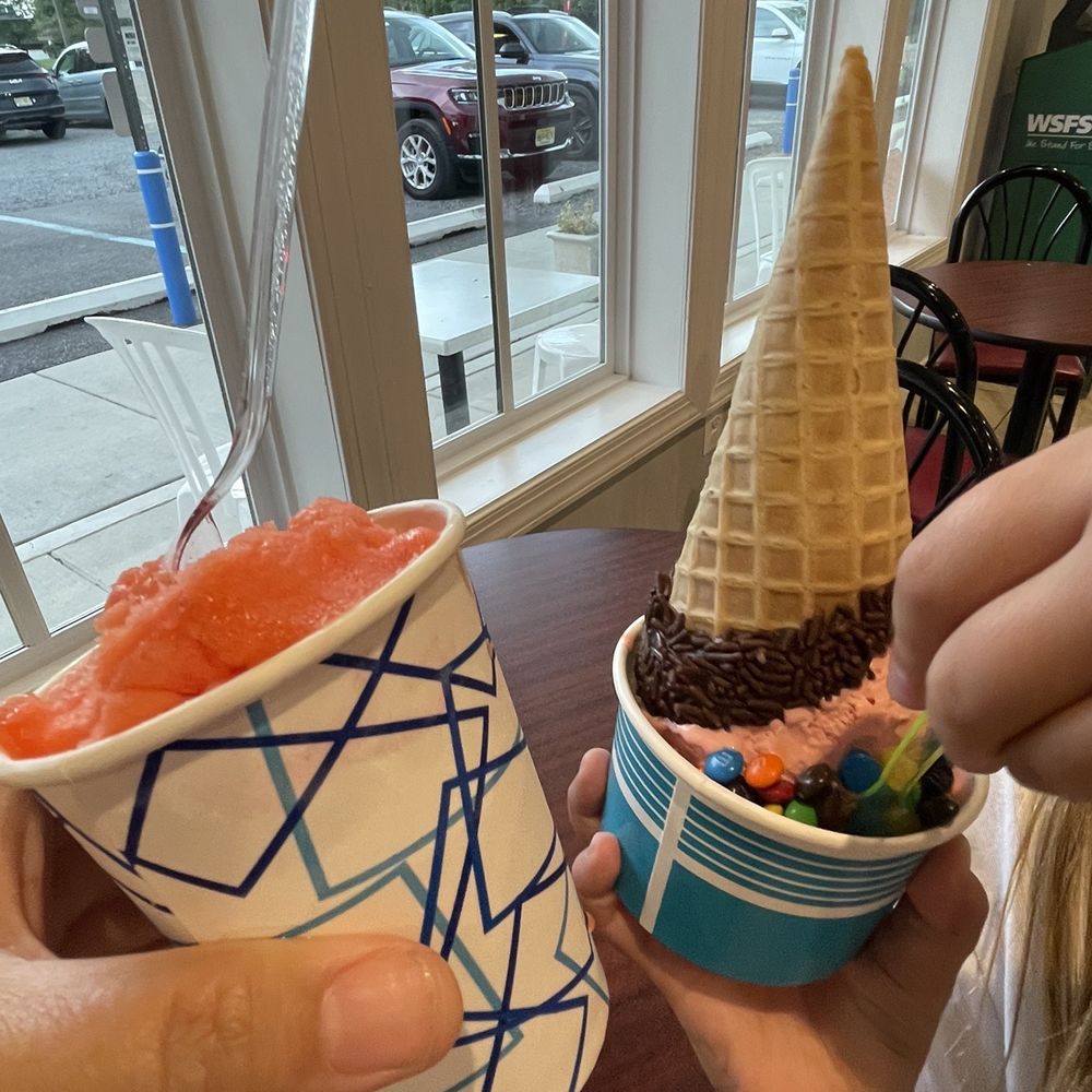 Peach berry water ice and strawberry ice cream in a waffle cone. Peach berry water ice and strawberry ice cream in a waffle cone.