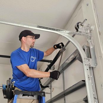 Up Down Garage Doors - Tightening up a torsion spring for a yearly tune up maintenance. - Garage Door Services Near Me Up Down Garage Doors - Tightening up a torsion spring for a yearly tune up maintenance. - Garage Door Services Near Me