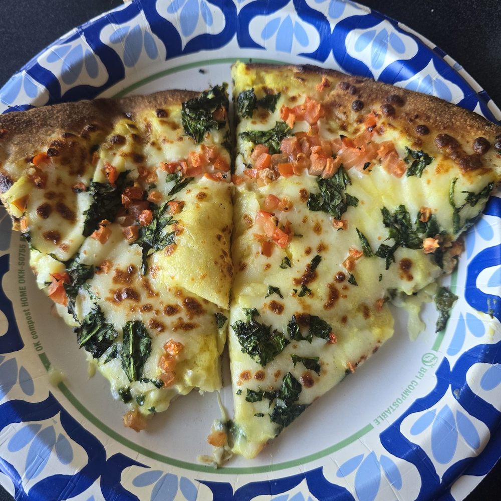 CoasT Pizza - Sunny side cut in half and one bite taken - Pizza Near Me - Girdwood, Alaska CoasT Pizza - Sunny side cut in half and one bite taken - Pizza Near Me - Girdwood, Alaska
