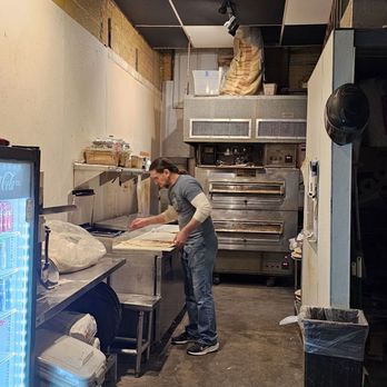 The Onion - a man working in a commercial kitchen - Pizza Near Me - Austin, Texas The Onion - a man working in a commercial kitchen - Pizza Near Me - Austin, Texas