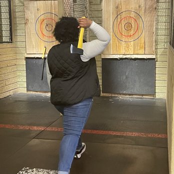 BATL Axe Throwing - a woman throwing a bat - Axe Throwing Near Me - Charlotte, North Carolina BATL Axe Throwing - a woman throwing a bat - Axe Throwing Near Me - Charlotte, North Carolina