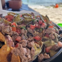 Restaurante Paamul - Beef nachos. It is baked, the cheese is melted, very light on beans, no guacamole or avacado. Beef is flavorful with a few gristly pieces.
