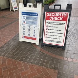 Social Security - Here's said sign- "laptops outside of the bag & no more than x2 guests per screening entry" where?