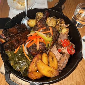 Marcus Bar & Grille - The Cookout: Jerk Chicken, BBQ Pork Ribs, Brisket, crispy potatoes, collard greens and plantains. - Cocktail Bars Near Me - Atlanta, Georgia Marcus Bar & Grille - The Cookout: Jerk Chicken, BBQ Pork Ribs, Brisket, crispy potatoes, collard greens and plantains. - Cocktail Bars Near Me - Atlanta, Georgia