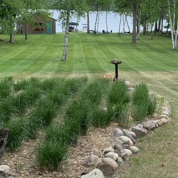 Kunnari LawnCare - a view of a grassy lawn with a bench in the foreground - Lawn Services Near Me - Remer, Minnesota Kunnari LawnCare - a view of a grassy lawn with a bench in the foreground - Lawn Services Near Me - Remer, Minnesota