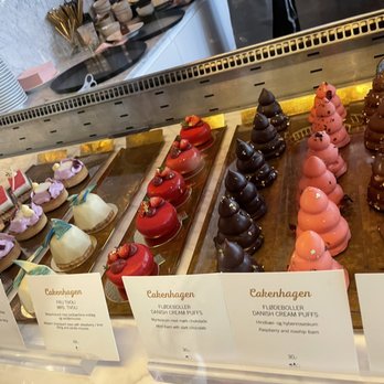 Cakenhagen - The 3 items on the right are call cream puffs.  It's all cream n chocolate. - Champagne Bars Near Me - København V, 84