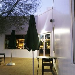tables and umbrellas outside a coffee shop