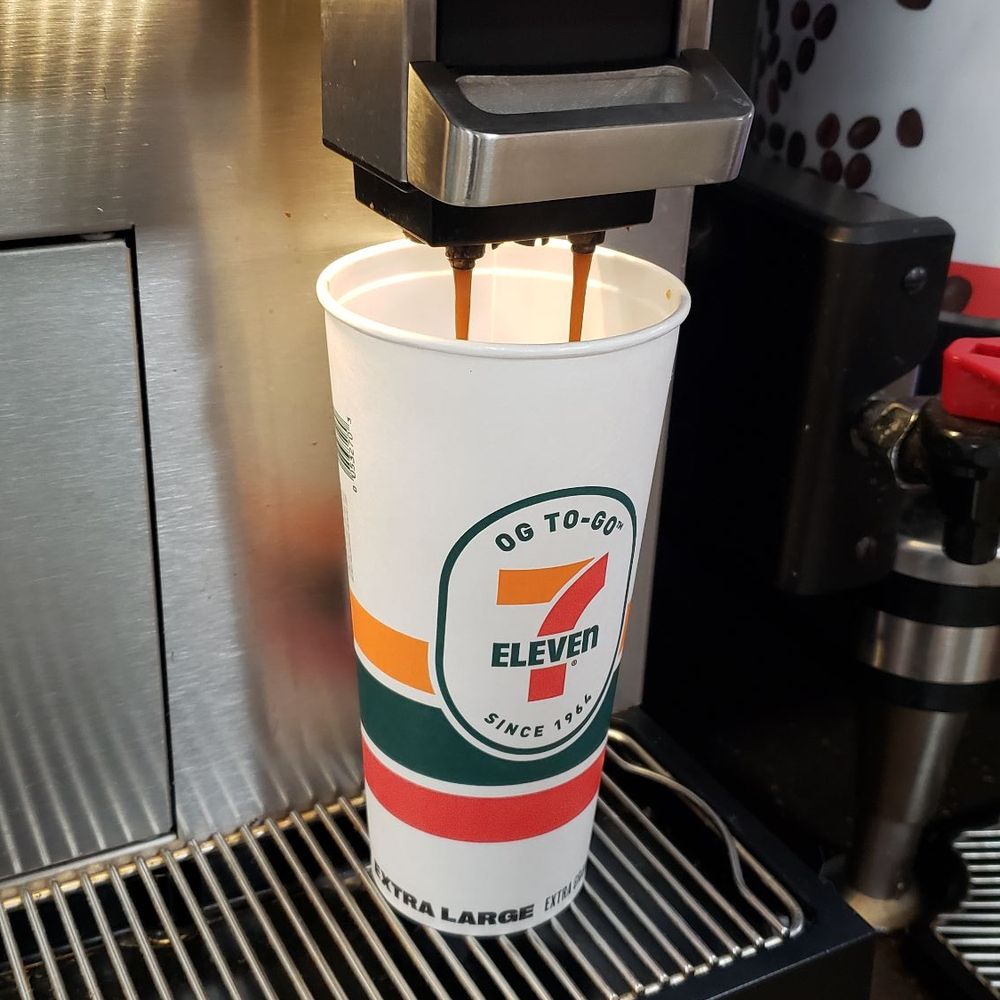 7-Eleven - a cup of coffee being poured into a coffee machine - Convenience Stores Near Me - Hempstead, New York