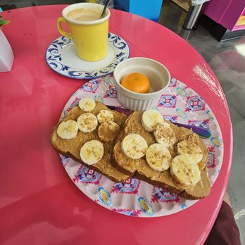 Amonie Jo's Coffee - The Sweet: Grain toast with peanut butter spread, banana slices, honey drizzle and cinnamon powder with an orange.   Cafe on leche to drink. - Coffee & Tea Near Me - Lakeland, Florida