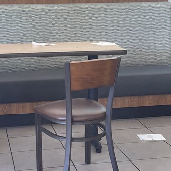 Pollo Tropical - a table and chair in a restaurant - Latin American Near Me - Daytona Beach, Florida