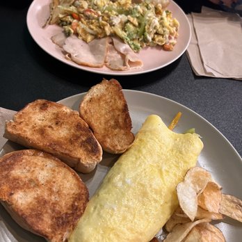 Granos Cafe - Omelette with vegetables cheese accompanied with homemade chips, slices of ham, and wheat toast. - Coffee & Tea Near Me - Aibonito, Puerto Rico