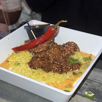 De Lazy Lizard - Spicy chicken with  jollof rice - American Near Me - Ocean City, Maryland